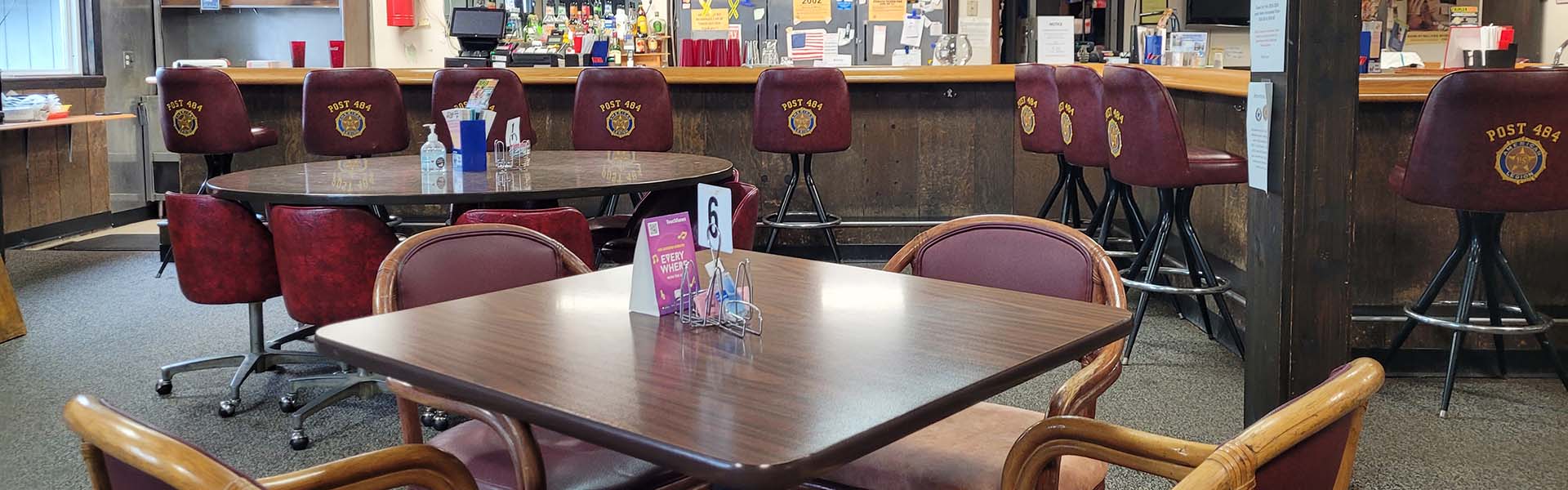 American Legion Post 484 dining room with burgundy leather chairs bearing the insignia